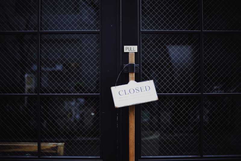 Gate with closed sign on it